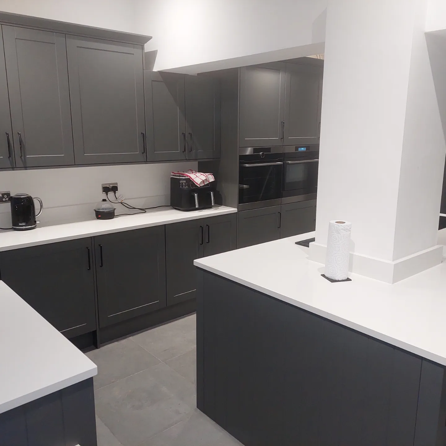 Modern grey kitchen cabinetry with integrated double oven